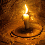 Салют, свечи, фонари Горящая свеча на подставке у стены аватар